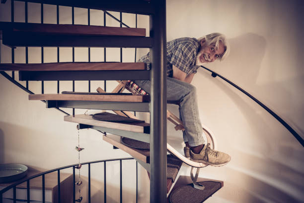 istock Senior Man Going Down Stairs On Sleigh 1667177563