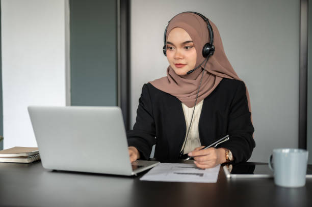 istock A confident Asian Muslim female call centre operator is working in the call centre office. 1667222371