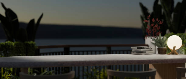 istock Copy space on a tabletop on a balcony with tropical plants and a beautiful nature view at night. 1667224606
