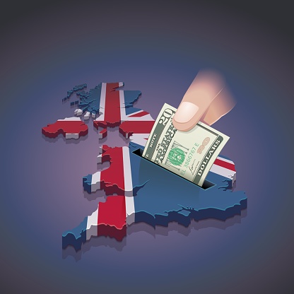 Map of the United Kingdom in the colors of the Union Jack in which a hand places a 20 dollar note on a dark background