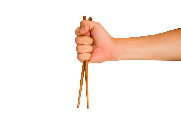 hand holding chopstick stock photo