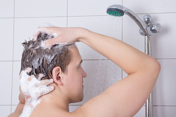 istock man washing his hair in shower 166723428