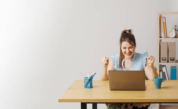 istock Successful woman connecting online and celebrating 1667248411