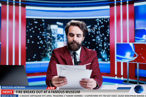 Anchorman reveals museum on fire breaking news, many artifacts and artworks are in danger of burning. News broadcaster being worried about historical pieces at famous landmark.