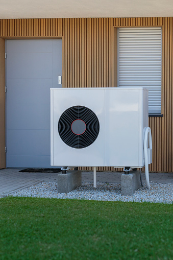 A heat pump outside a residential home, showcasing an eco-friendly heating solution.