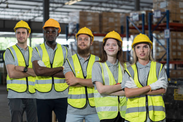 istock Group of diverse warehouse workers standing with crossed arms in storage warehouse. Team of male and female warehouse workers at work. Completed finish job. Successful of work concept 1667295201