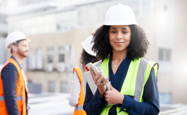 istock Engineering, technology and portrait a woman outdoor for planning, building or construction site. African person or engineer with network connection in a city for project management with a team 1667298583