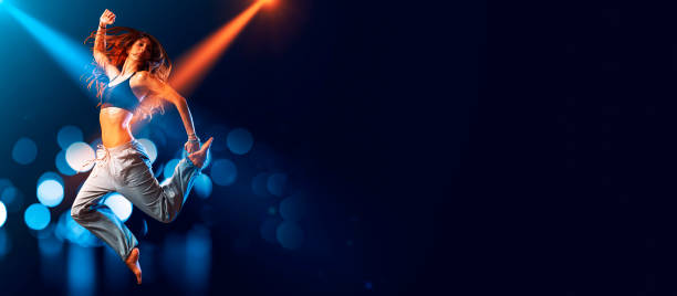 istock Athletic woman dancing on stage 1667313186