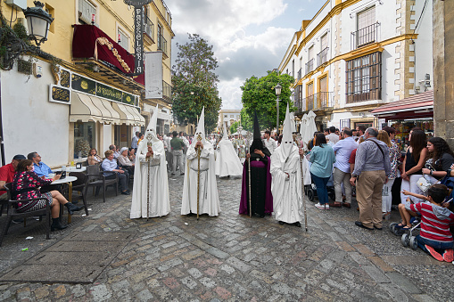 Jerez de la Frontera, Spain - September 8, 2023: Brotherhood of Nazarenes of Jerez de la Frontera tunics with tunics on the street.