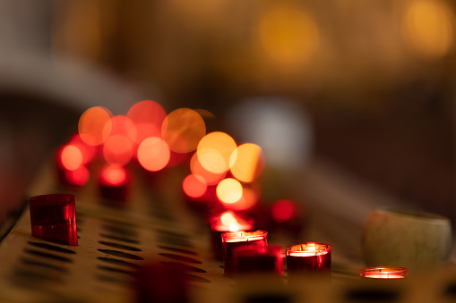 Red blurry light from small candles - bokeh effect. Mid shot