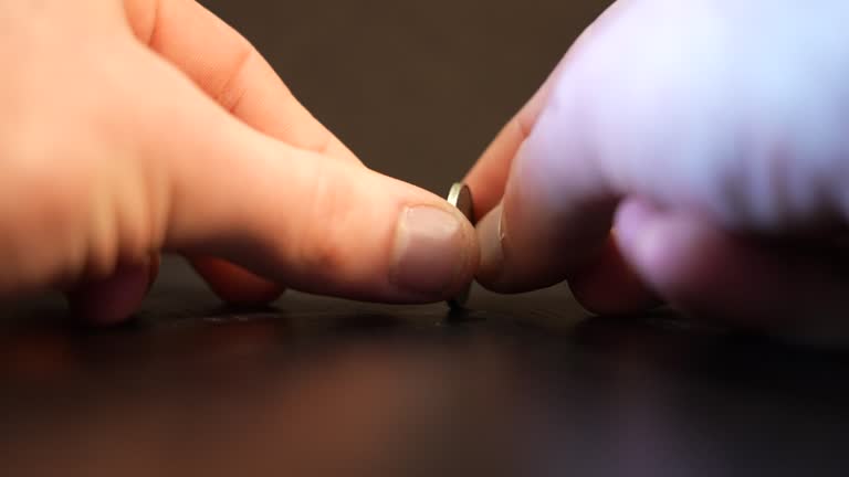 Spinning an American nickel coin.