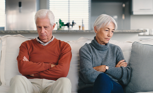 Old Couple, divorce and senior people on sofa with anxiety and ignore with infidelity, marriage and frustrated. Stress, person and woman in lounge, depression and fight with conflict or problems
