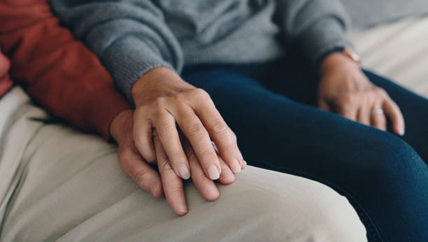 istock Couple, hands and love or support on home sofa with understanding, commitment and care. Closeup of man and woman together in a house with healthy marriage, compassion or empathy and trust in partner 1667362593