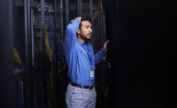istock Server room, mistake or male technician with hardware or cables for cybersecurity glitch or machine problem. Doubt, thinking or confused engineer with error in information technology or IT support 1667364783