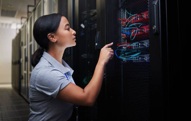 istock Woman, cable and engineer in server room to check inspection of cloud computing. Information technology, wire and technician in data center, networking in maintenance or cybersecurity of system admin 1667364800