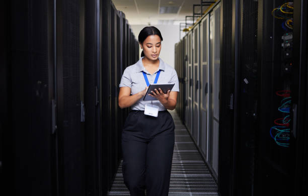 istock Woman, tablet and engineer in server room on research for programming at night. Information technology, inspection and technician in data center reading, network maintenance or typing software code 1667364805