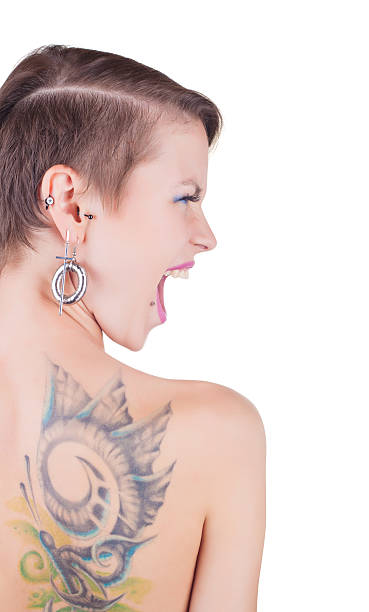 Tattoos and piercings Young girl with a tattoo on her back and piercings isolated on white background back shoulder tattoos for women pictures stock pictures, royalty-free photos & images