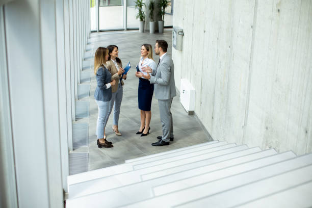istock Young startup team have a discussion by stairs in the office corridor 1667374500