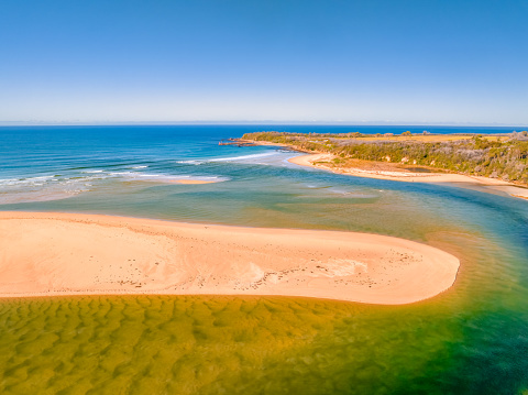 Blue sky daytime coast views over the sea and the Wallagaraugh River at Mallacoota, Victoria, Australia