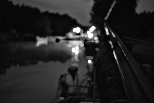 Sailboat detail and abstract defocused Lights of Canal Lock, Brandenburg-State, Germany