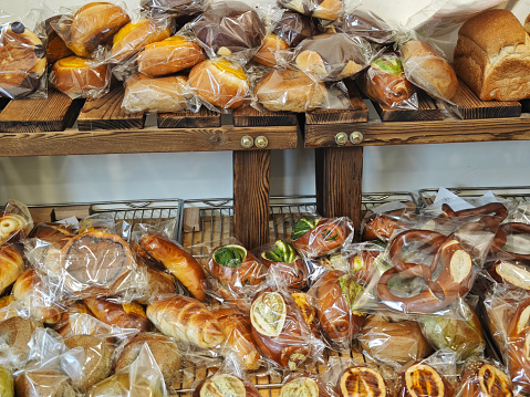 various buns, bagels and pretzels sold in bakery