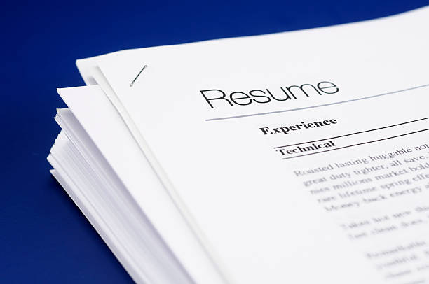 Resume Stock photo of mock resume on blue help wanted sign photos stock pictures, royalty-free photos & images