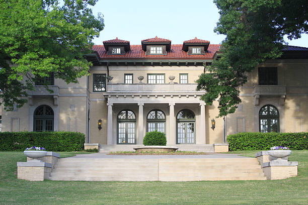Tulsa Garden Center Exterior with Stairs and Lawn The lovely Tulsa Garden Center, located in Tulsa, Oklahoma, formerly a mansion, is photographed. This former mansion was completed in 1921 in the Italianate Style, and features a cobblestone driveway. It was originally constructed with 21 rooms and 10 bathrooms. The garden center serves as an educational resource and meeting place for environmental and horticultural groups throughout the Tulsa area. tulsa landmark stock pictures, royalty-free photos & images