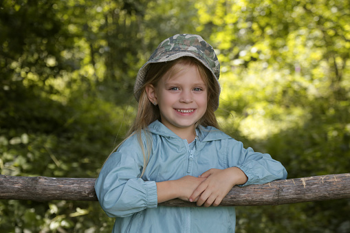 Stock portrait of a young attractive cowgirl in the country.