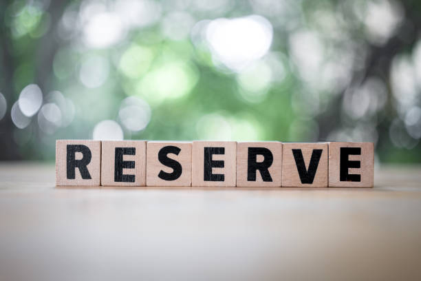 istock Reserve word is written on wood block. Reserved text on wood table. 1667415706
