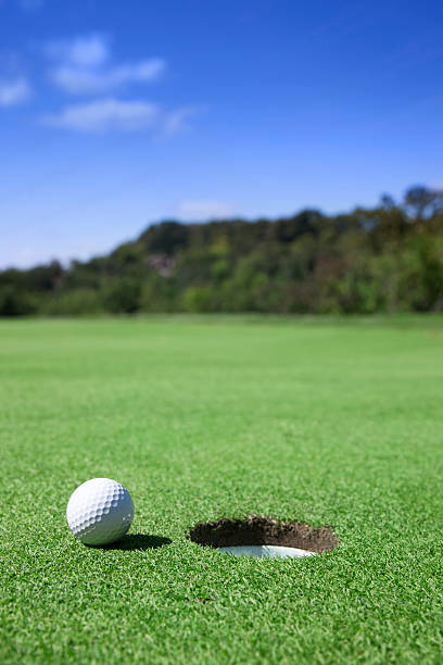 istock Golf Ball On Edge of Hole 166744489