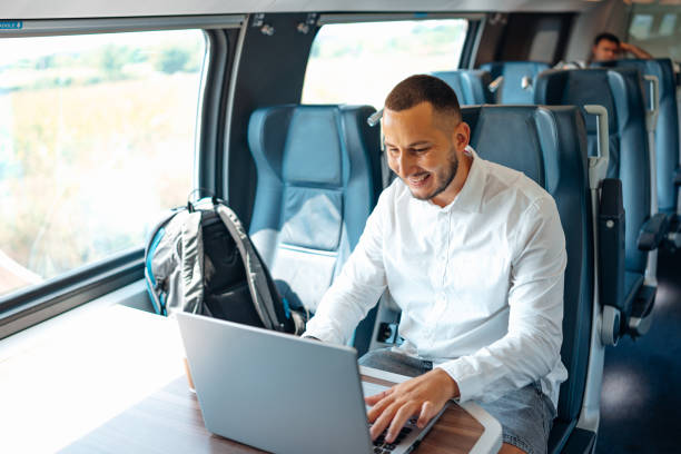 istock Young Caucasian businessman working on his laptop, while riding a train 1667448088