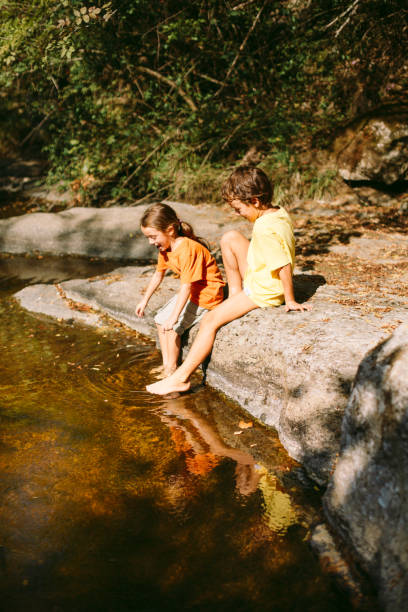 istock Children playing and explore the nature by the river 1667469592