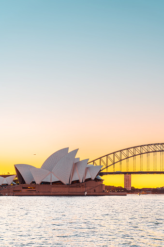 Sydney, Australia - April 20, 2022: Sydney Opera House with Harbour Bridge at sunset viewed from Royal Botanic Gardens at sunset time