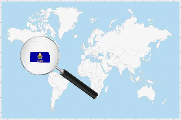 Vector illustration of Magnifying glass showing a map of Kansas on a world map.