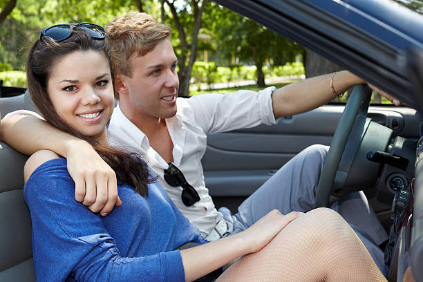 istock Young couple sits embraced in a cabriolet 166750668