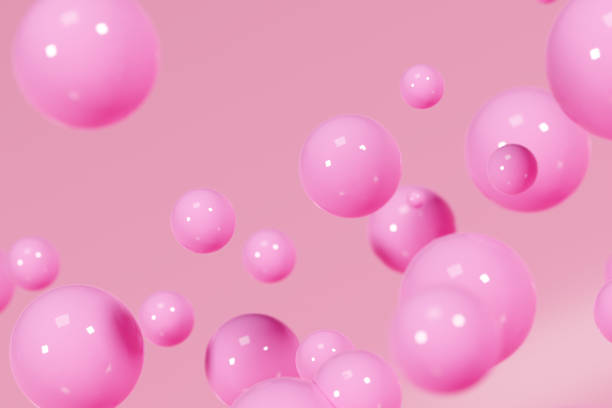 istock Pink shiny balls on peachy background 1667528403