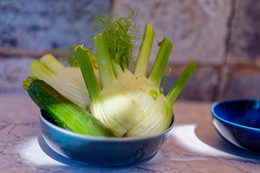 Closeup shot of a young woman chopping vegetables in the kitchen