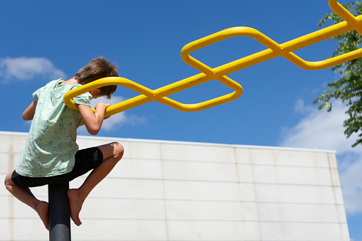 Child climbing a playground structure