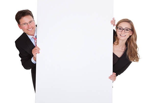 Professional man and woman with a blank sign