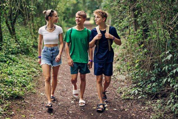 Three teenage kids are walking walking in a forest in Gloucestershire.\nShot with Canon R5