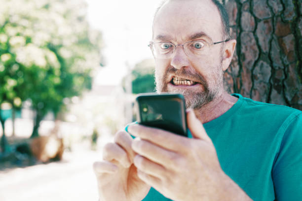 Old man with smart phone stock photo