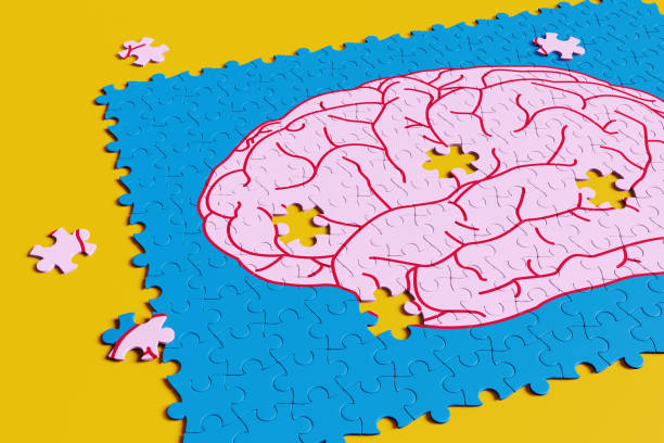 istock Jigsaw puzzle having a pink cartoon brain with missing pieces on yellow background. Illustration of the concept of creativity and ideas 1667594222