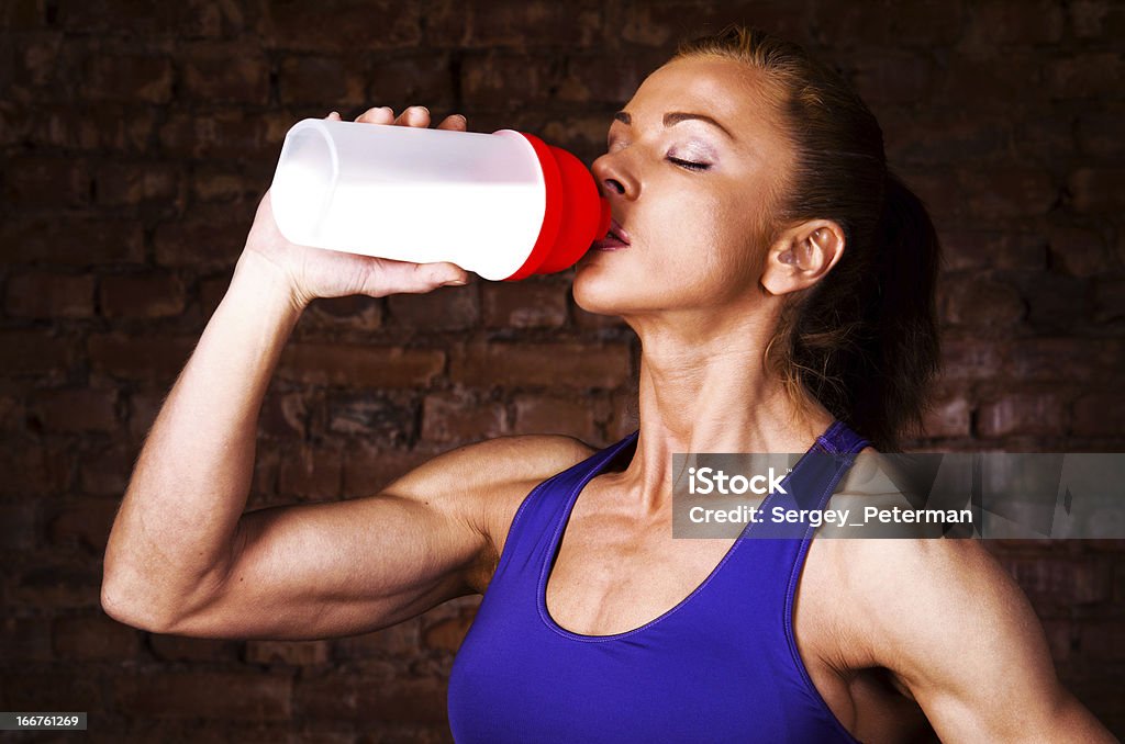 strong woman strong woman is drinking sports nutrition Protein Drink Stock Photo