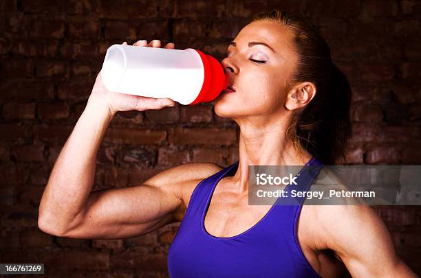 Strong Woman Stock Photo - Download Image Now - Protein Drink, Nutritional Supplement, Drinking