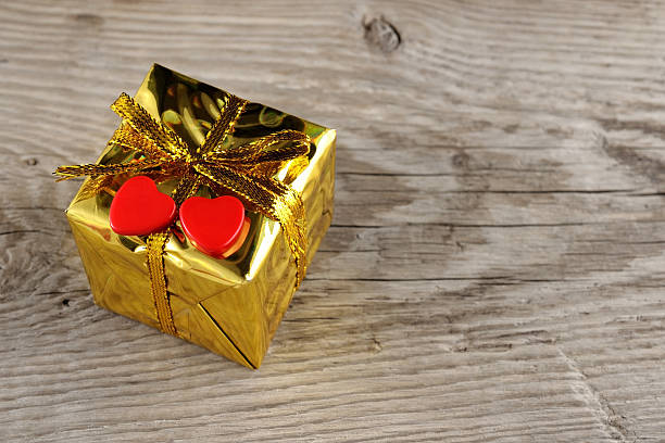 istock Valentine gift box with two hearts on wooden background 166761285