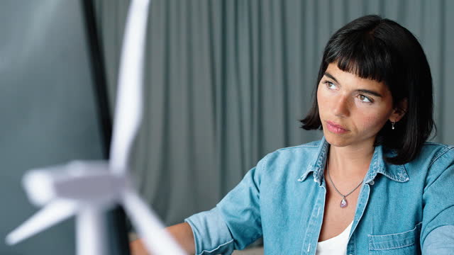 Young businesswoman sitting at desk working on desktop comptuer at startup