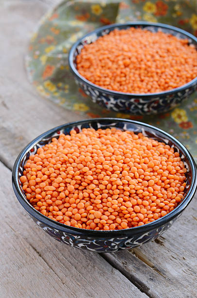 istock Oriental bowls with red lentils on wooden background 166764415