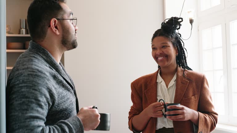 Startup colleagues discussing at coffee break in office