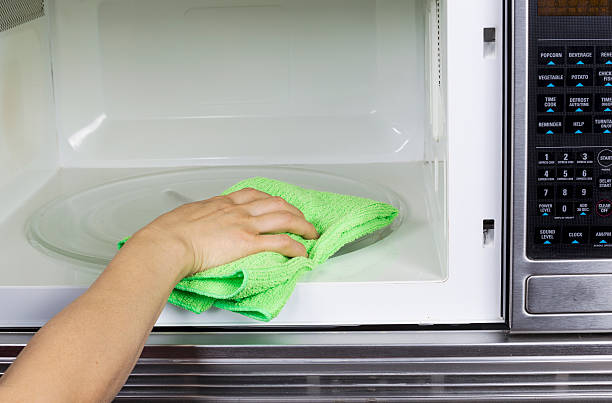 istock Cleaning inside of Microwave Oven 166766994