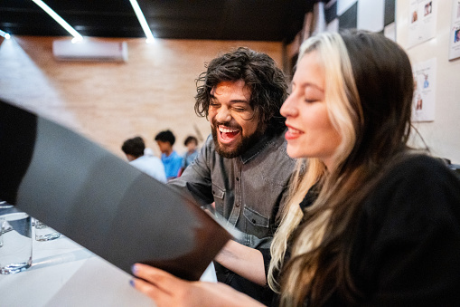 Judges talking while looking at contestants' files in a music contest